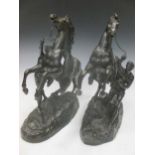 A pair of hollow bronze Marly horses, 42cm