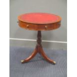 A Georgian style mahogany revolving drum top occasional table with four drawers 69cm high and 61cm