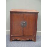 A 20th century Chinese hardwood two door cupboard, inside one fixed shelf with two drawers 84 x 74 x