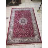 A Persian style wool rug, with a predominant red ground, 200 x 300cm, and another similar (2)