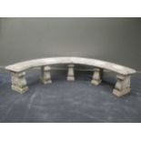 A semicircular composite garden bench on five lyre shaped supports
