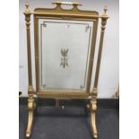 A gilt fire screen with glazed panel