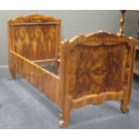 An early 20th century continental walnut single bedstead with inlaid shaped head and footboard, 98