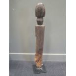 An early 20th century African carved wood fertility statue of phallic form