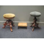 Two Victorian piano stools with swivel tops on tripod legs, one with dolphin supports and a