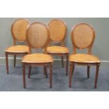 A set of four Louis XVI style salon chairs with caned oval back and seat on fluted tapering legs. (
