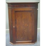 An early 19th century oak and mahogany cross-banded corner cupboard with single door, 110 x 81cm