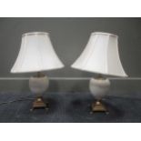 A pair of ovoid and brass mounted table lamps