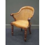 An early Victorian walnut bergere arm chair