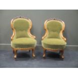 A pair of Victorian walnut frame easy/ nursing chairs (2)