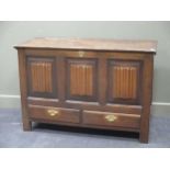 An antique oak mule chest with triple 'linen fold' panelled front above two drawers, 84 x 127 x 54cm