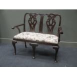 An Edwardian George III style mahogany two seater hall sofa with acanthus leaf carved cabriole