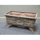 A Victorian style cast metal trough planter on four leaf cast feet 78cm wide, 38cm deep