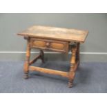 A low oak table with single drawer on four turned column legs and stretchers 57 x 77 x 51cm