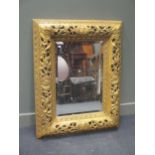 A pierced gilt wood frame wall mirror with bevelled glass, reproduction 114 x 91cm