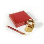 Cartier - A 'must de Cartier' travelling alarm clock and ballpoint pen,