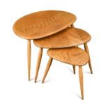A nest of three Ercol elm Pebble tables,