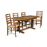 Attributed to Heal's, a limed oak Cottage style refectory dining table and four chairs,