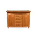 § David Linley, a bespoke walnut bowfront cabinet with sycamore stringing,