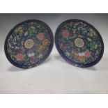 A pair of Cloisonné plates, the blue ground decorated with peonies, 30cm diameter