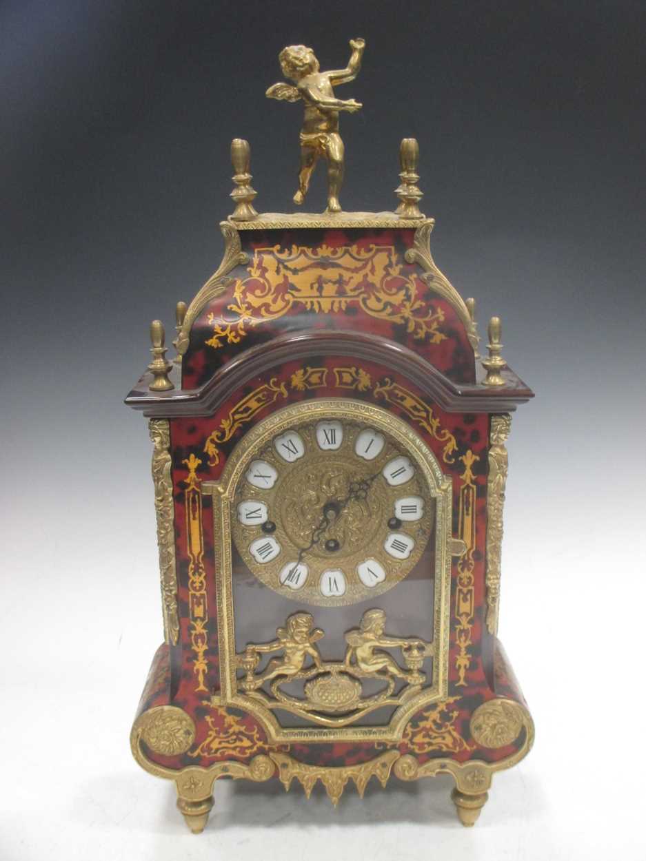 A Boulle mantel clock, surmounted by a cherub, 54cm high