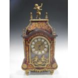 A Boulle mantel clock, surmounted by a cherub, 54cm high