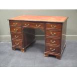 A George III style mahogany twin pedestal desk, with tooled red leather inset surface, 76cm high,