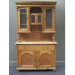 a late 19th or early 20th century continental pine cabinet, the upper part enclosed by glazed