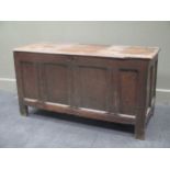 An 18th century oak panelled coffer on stile feet 64 x 121 x 52cm