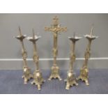 An early 20th century brass table standing crucifix, 66cm high, together with four matching
