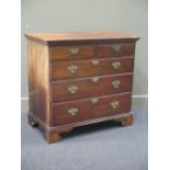 An 18th century walnut chest of drawers, with a moulded cornice above two short over three long