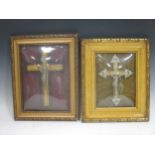 An early 20th century framed metal crucifix and another (2)