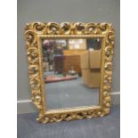 A carved giltwood mirror 87 x 75cm, together with another smaller mirror in a gilt frame 63 x