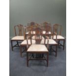 A set of eight George III style mahogany dining chairs, with moulded serpentine top rails and tied