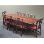 A George III style twin pillar dining table and eight dining chairs, including two carvers, 77 x