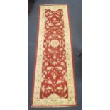 A 20th century Caucasian red ground runner 248 x 78cm together with a pale pink runner 338 x 88cm (