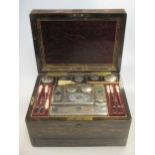 A 19th century lady's travelling toiletries set, the fully fitted coromandel box with two secret