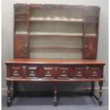A 17th century and later oak dresser, the upper section with shaped cornice and split turned