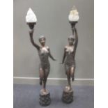 A pair of 20th century bronze lamps in the style of dancing ladies, 148cm high (inc glass shades)