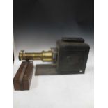 A Victorian brass and tin slide projector and slides