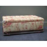 An Ottoman in floral upholstery with close button top 34cm x 99cm x 57cm