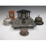 Three metal counter bells, a stone desk tray and two small clocks (6)