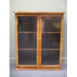 An early 20th century walnut display cabinet, comprising of a pair of glazed doors 127 x 105 x 41cm