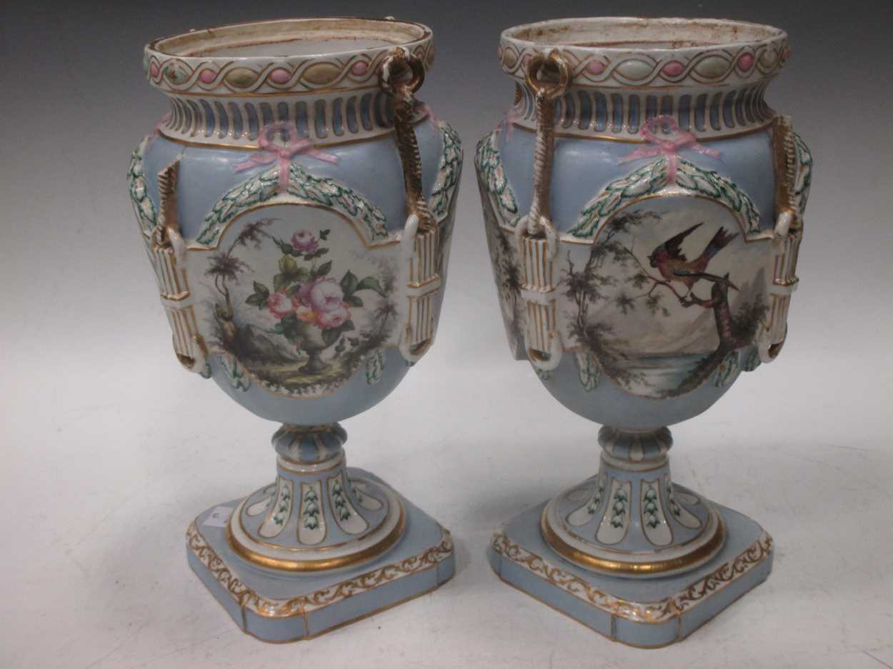 A pair of Continental porcelain pale blue ground vases, 19th Century (lacking covers), applied