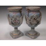 A pair of Continental porcelain pale blue ground vases, 19th Century (lacking covers), applied