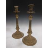 A pair of early 20th century pressed brass candlesticks, 49cm high