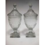 A pair of 19th century cut glass confitures, of urn form with domed covers, faceted knops and square