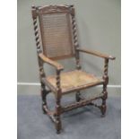 A late 17th century high back arm chair,