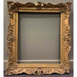 A pair of 19th century swept gilt frames. 75 x 63cm sight size, 77 x 65cm rebate size; 102 x 90cm