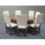 A solid oak George II style drop leaf table on pad feet, together with eight high back dining chairs